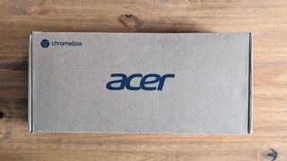 An Acer Chromebox CXI4 mini PC sitting on a wooden desk