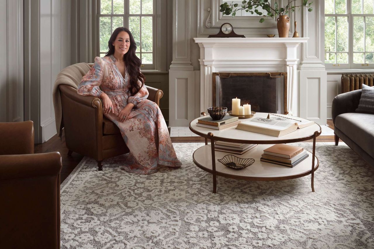 Joanna Gaines smiling in a decorated living room