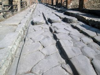 The passage of carts over decades could cause ruts (like the one shown here), particularly in high-traffic areas of Pompeii. 