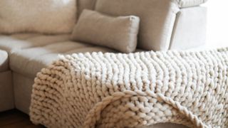 sofa with blanket draped over it