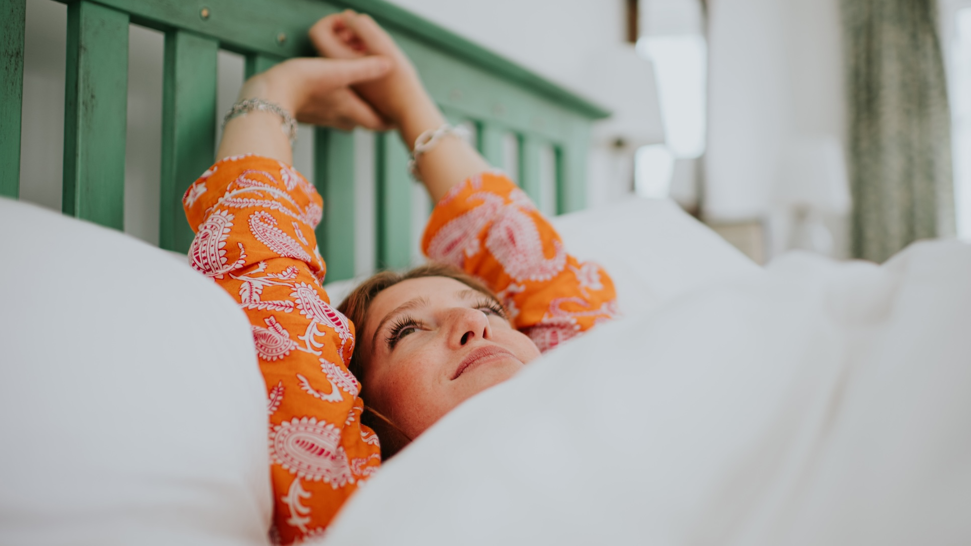 woman stretching in bed