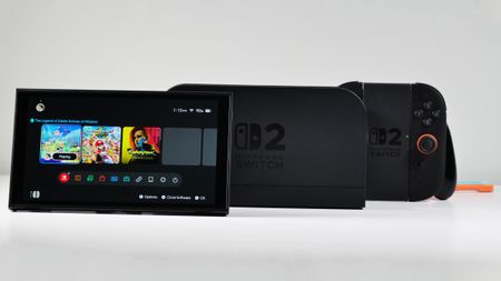 Nintendo Switch 2, Dock, Joy-Con 2 Grip, and Straps displayed on a white desk.