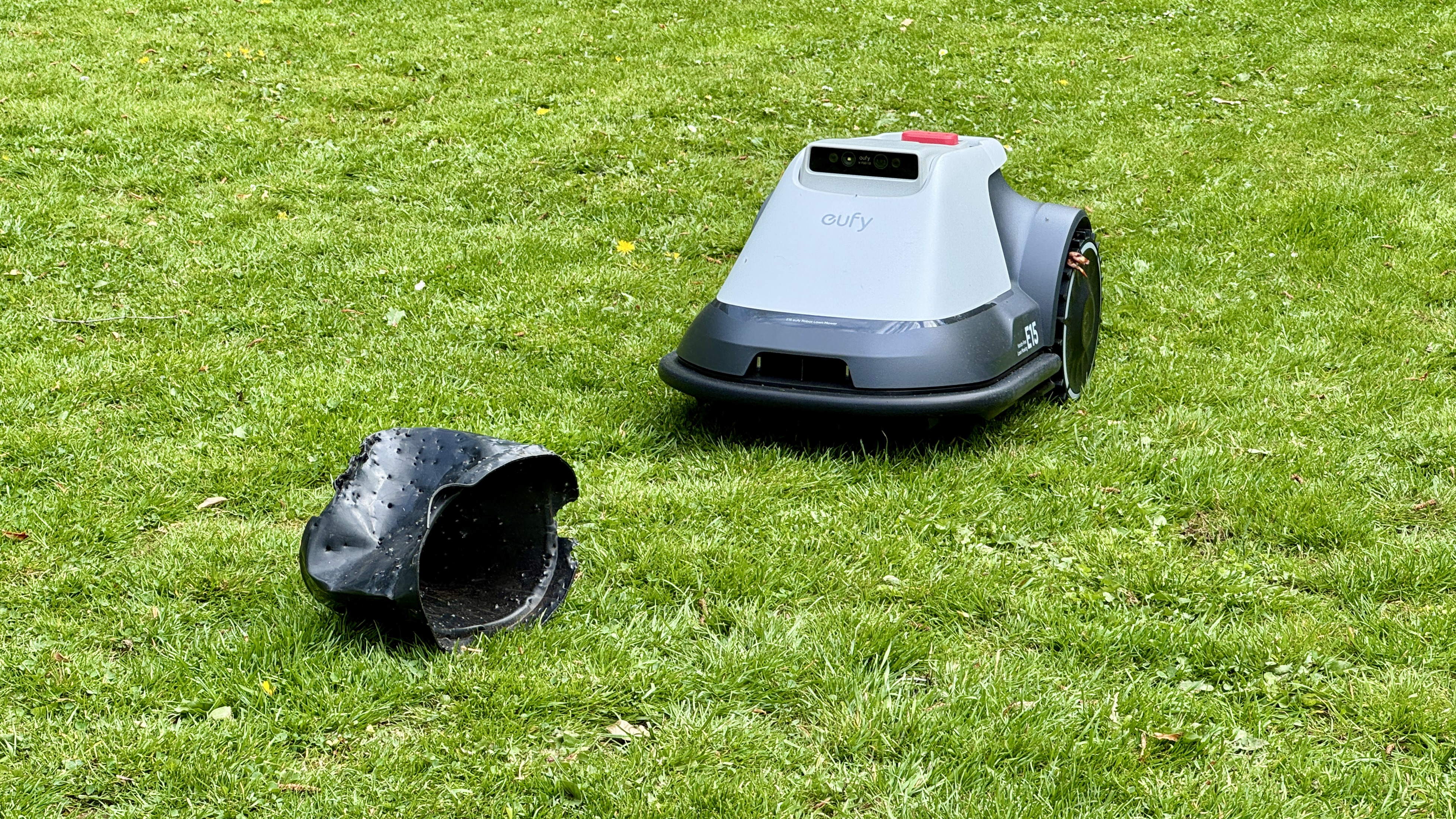 Eufy E15 robot lawn mower approaching an obstacle