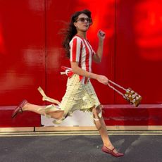 katyaklema wears a red striped top, yellow skirt and red ballet flats
