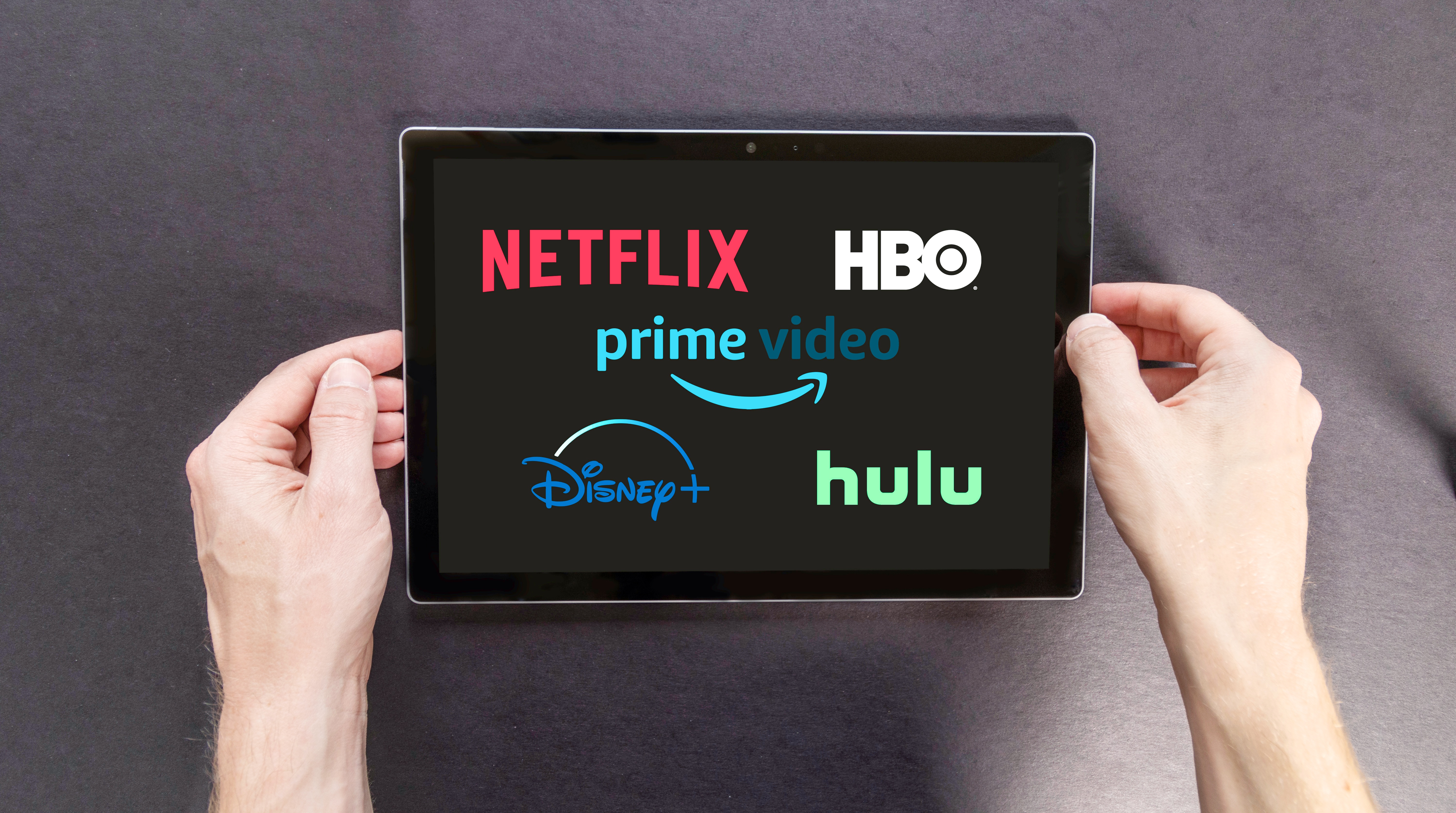 Netflix, HBO, and Prime logos on the tablet