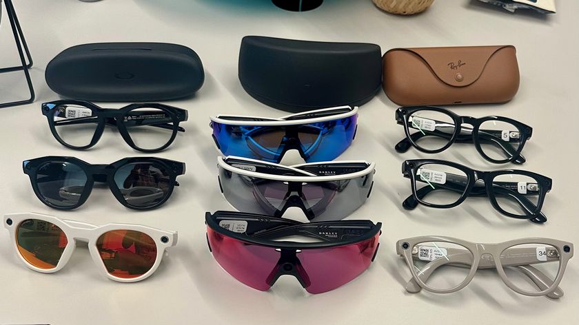 Three Oakley Meta HSTN, three Oakley Meta Vanguard, and three Ray-Ban Meta (Gen 2), along with cases, sitting atop a table in various styles.