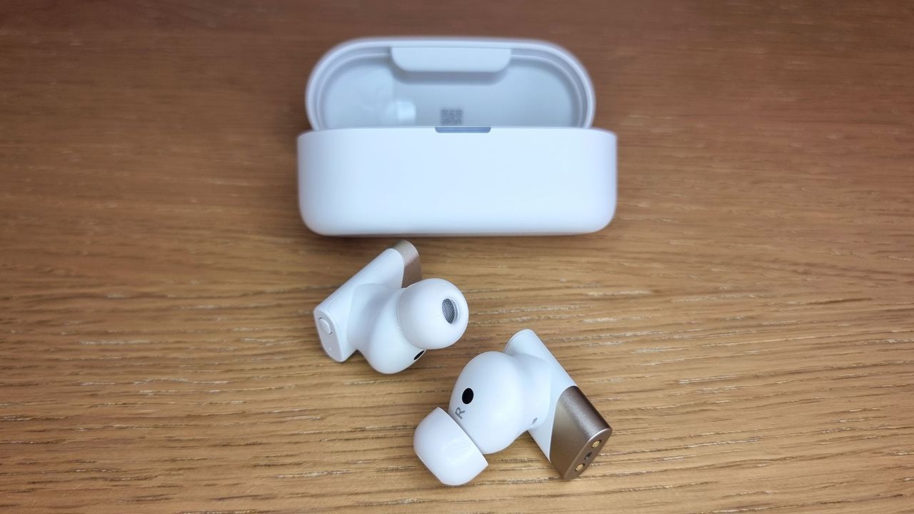 a picture of the Status Pro X earbuds and the open charging case