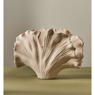 beige stoneware vase in the shape of a gingko leaf