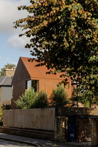 Corten cladding tones with the original brick