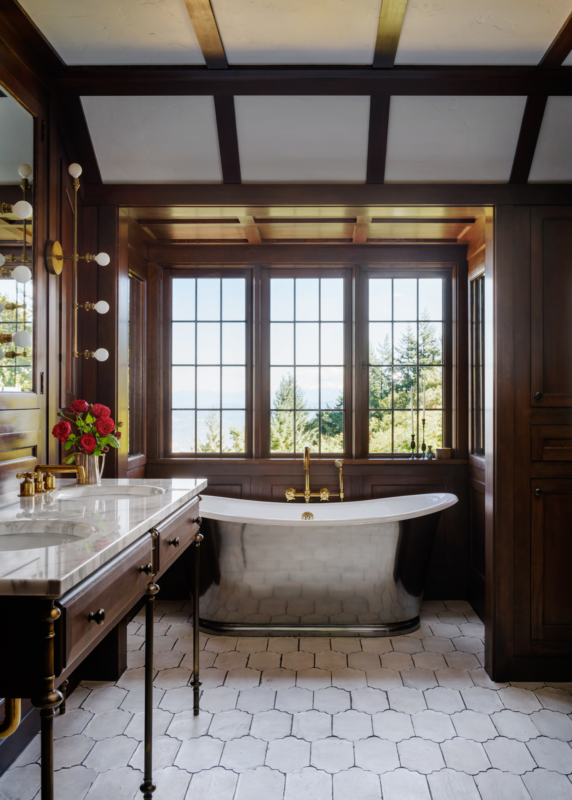 A bathroom with a large tub, brown walls, and large windows