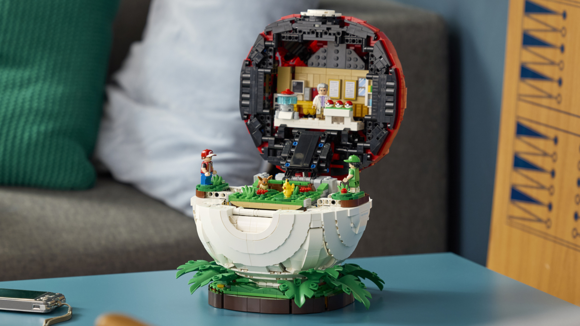 Lego Pokemon Poke Ball diorma open on a coffee table in front of a sofa