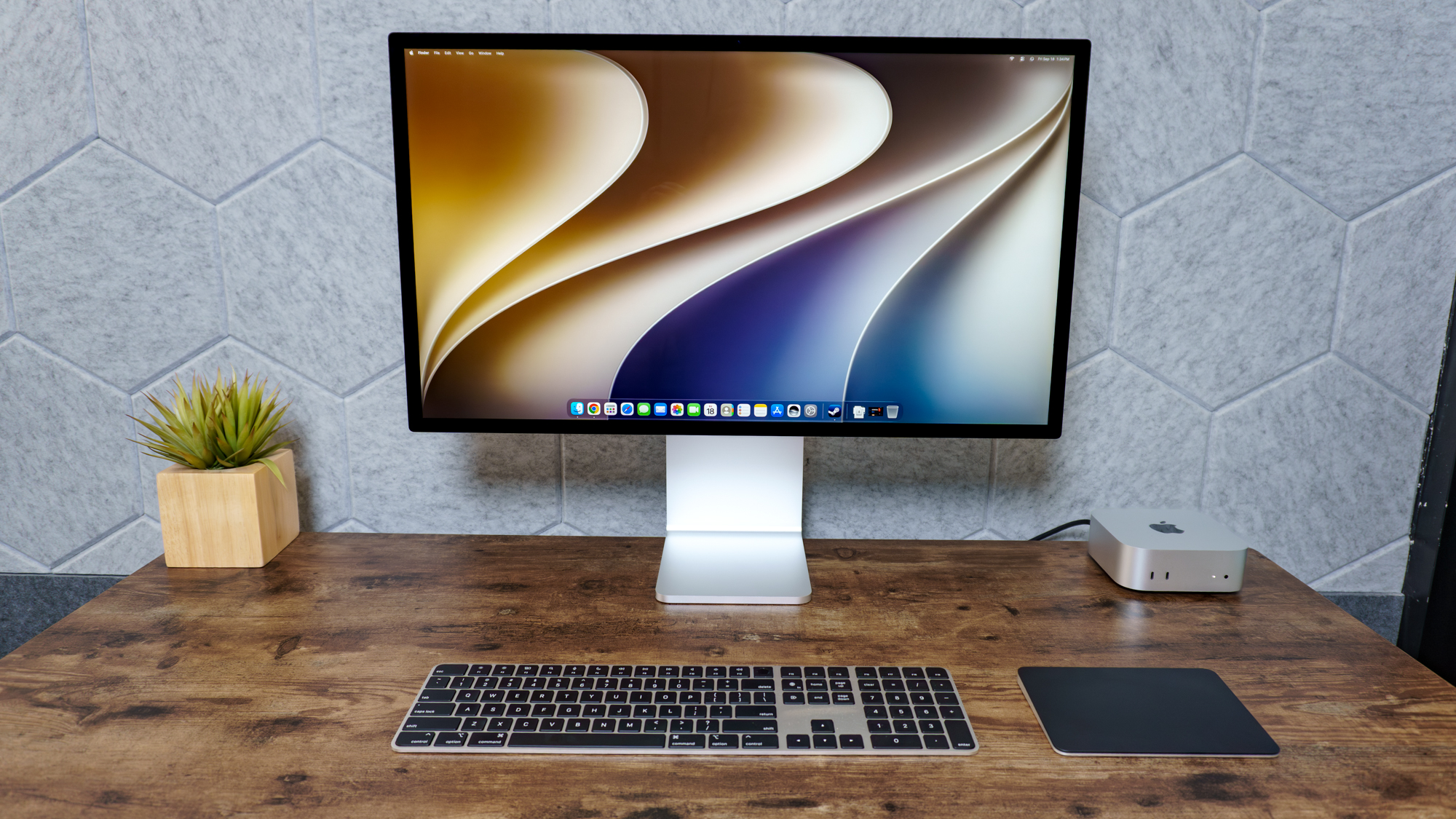 A desk setup built around the Mac Mini with M6 with an Apple Studio Display XDR monitor