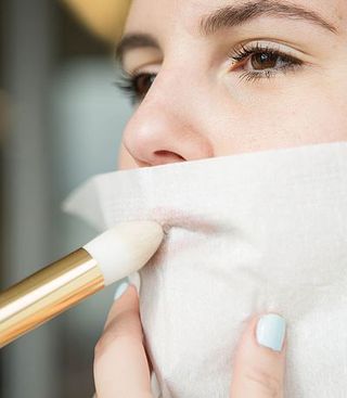 Dusting Translucent Powder Through Tissue Onto Lips