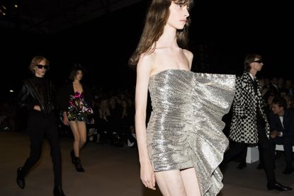 model wearing metallic silver fabric outfit 