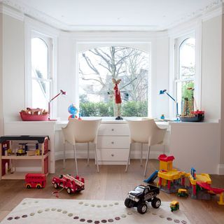 Kids room with white walls and wooden flooring