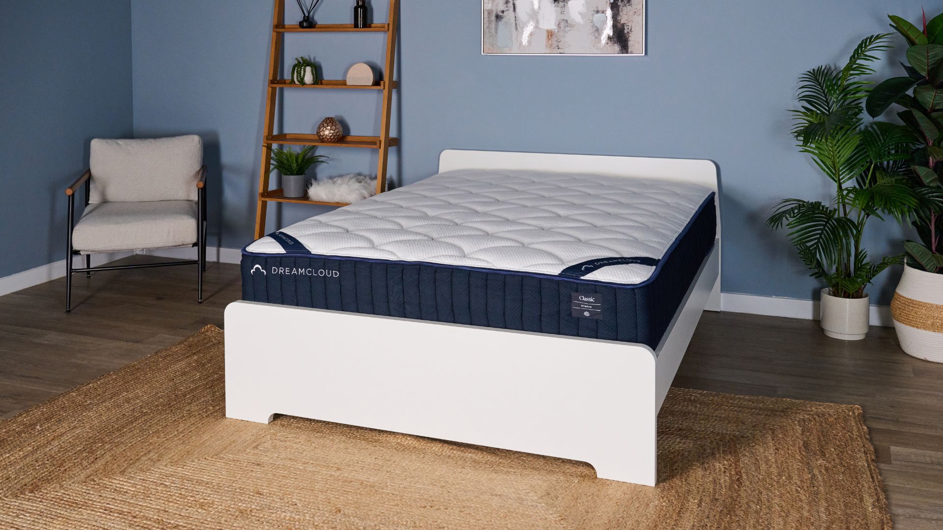 The DreamCloud Classic Hybrid Mattress in a blue bedroom.