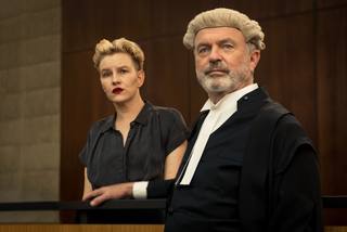 Kate Mulvany as Kate Lawson and Sam Neill as Brett Colby SC standing in a courtroom as part of The Twelve cast 