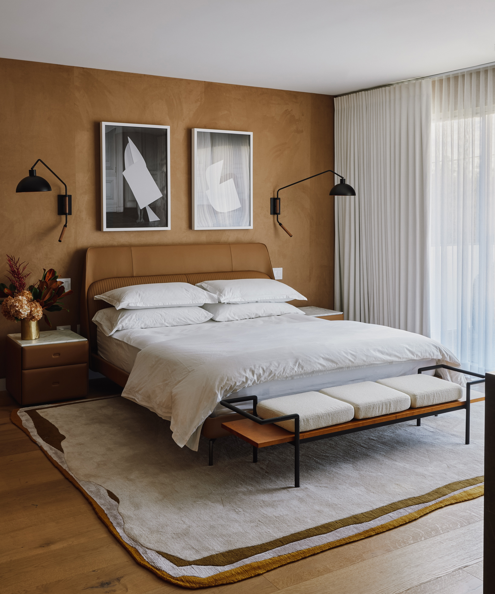 wood bedroom with large white bed and art above it