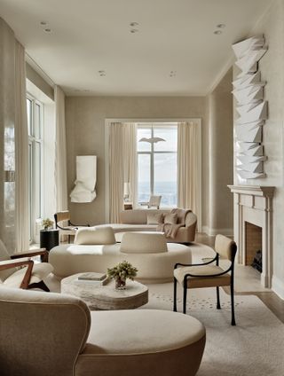 White living room with boucle conversation sofa and textured walls