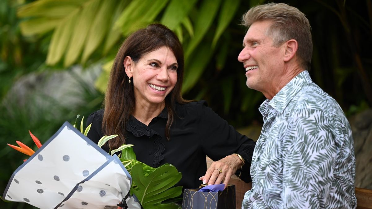 Theresa Nist holds a bouquet of flowers as she sits next to Gerry Turner on The Golden Bachelor Season 1.