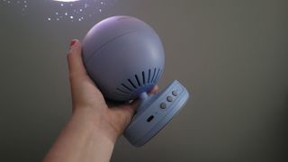 Review photo of the Pococo Galaxy Projector being held up in a dark room