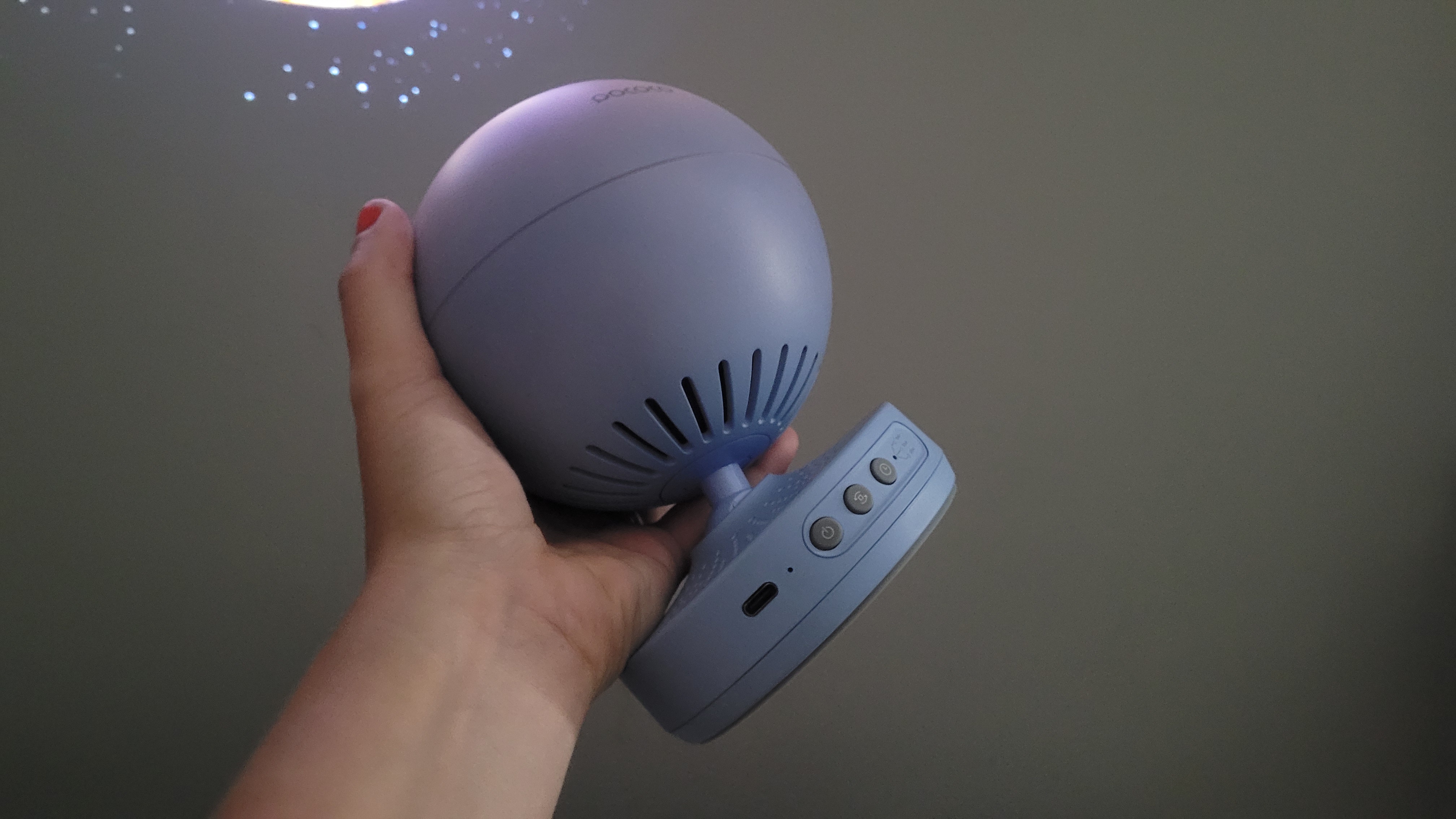 Review photo of the Pococo Galaxy Projector being held up in a dark room