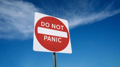 picture of road sign saying "Do Not Panic"