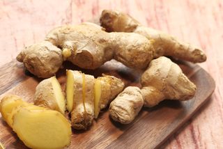 Ginger root on wooden chopping board