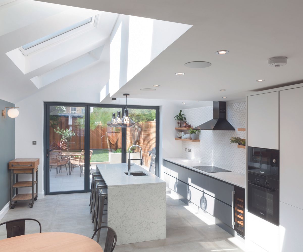 a contemporary pitched roof kitchen extension with skylights causing a feeling of brightess and openess
