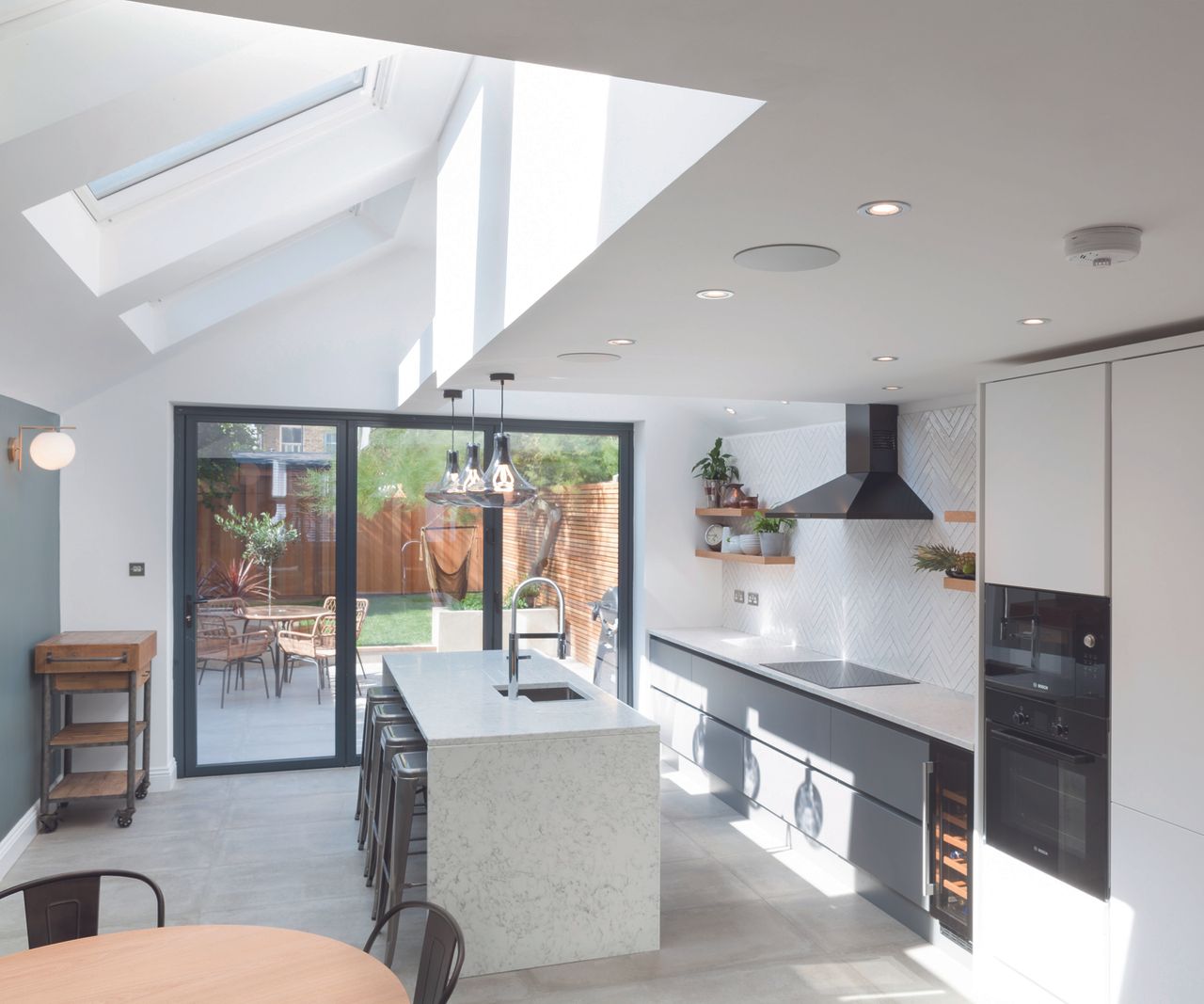 a contemporary pitched roof kitchen extension with skylights causing a feeling of brightess and openess
