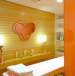 A bright spa room with oranges and yellow