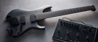 Ibanez QX527B headless guitar shot on grey surface