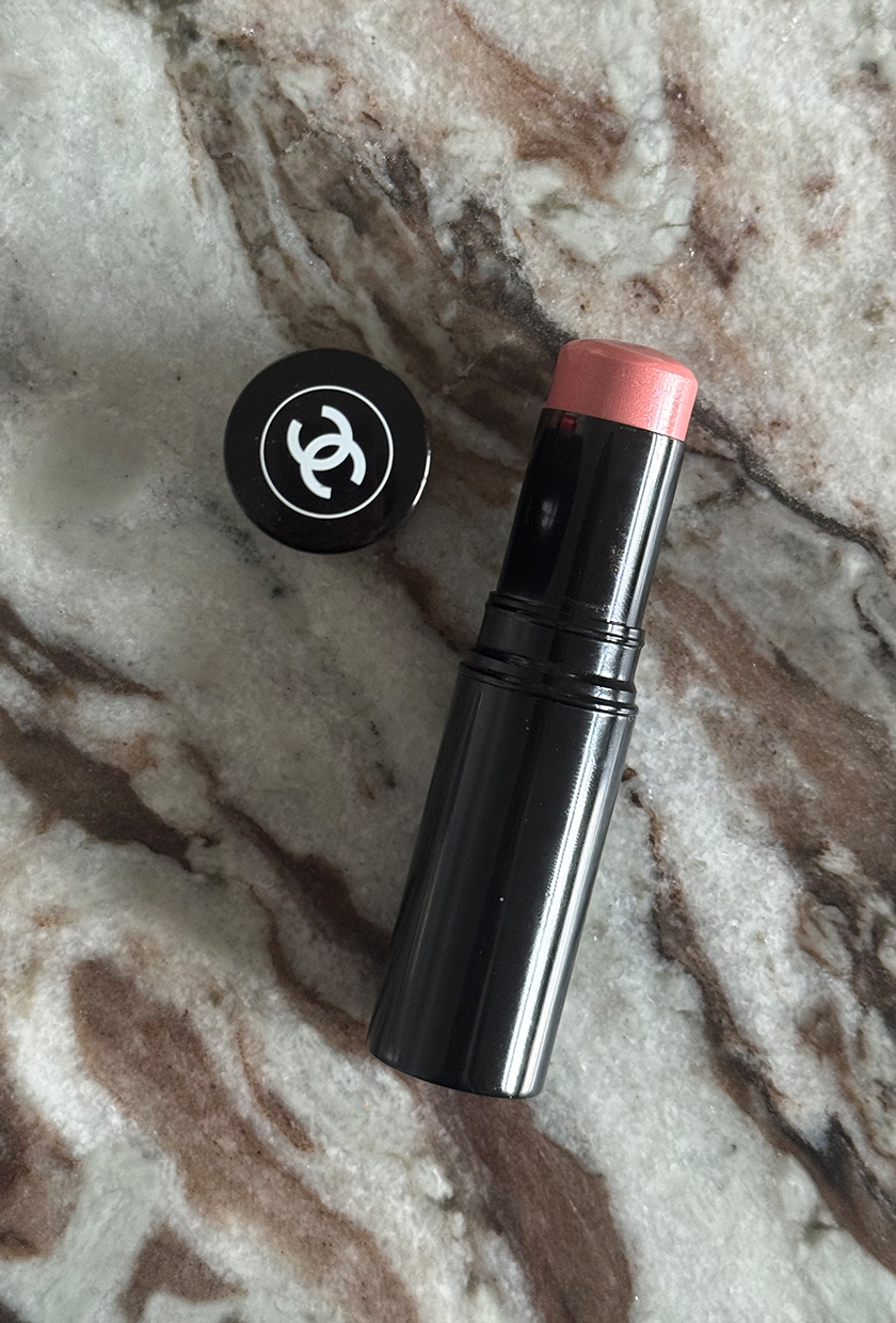Chanel le baume essentiel highlighting stick on a marble table