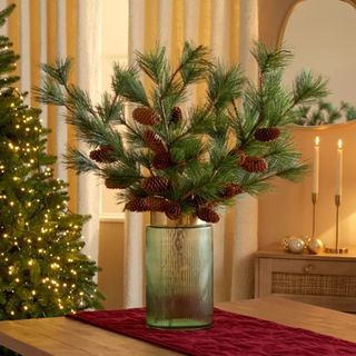 Pinecones and fir leaves in silver vase