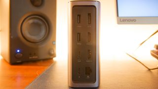 A silver Ugreen USB-C Triple Display Docking Station sitting on a desk