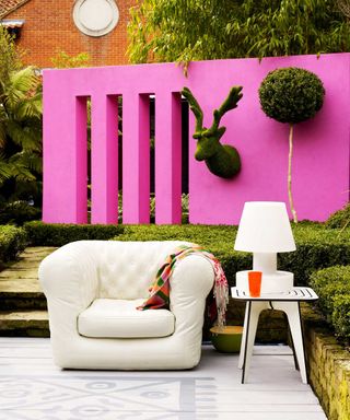 pink wall with painted rug on deck