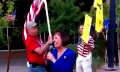 Sharron Angle followed up a Tea Party speech Friday with an impromptu performance of "God Bless the USA," while supporters waved flags behind her. 