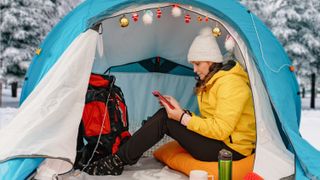 Woman in tent decorated for Christmas