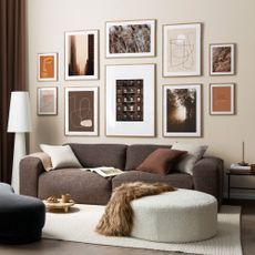 A light brown living room with a gallery wall and a fur throw over brown couch