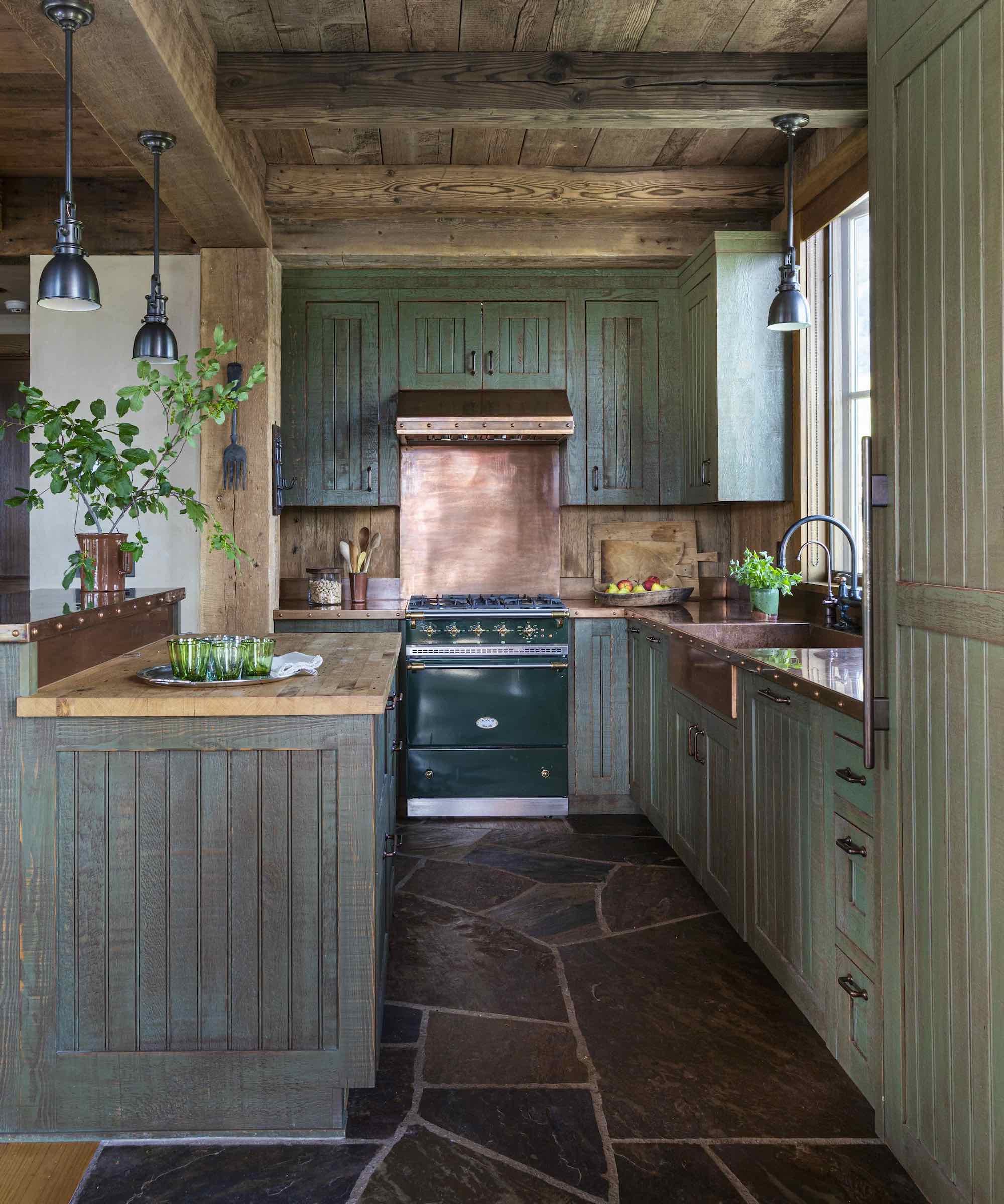green kitchen with copper backsplash