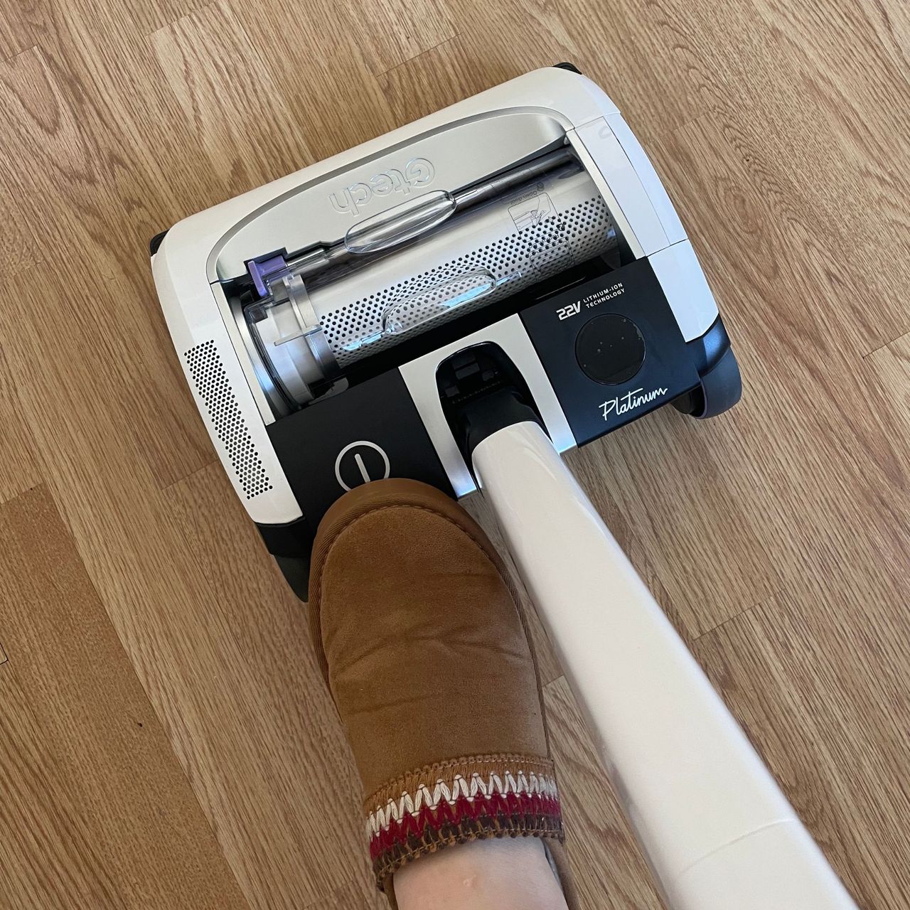 Foot pressing the controls of the Gtech Airram platinum vacuum cleaner