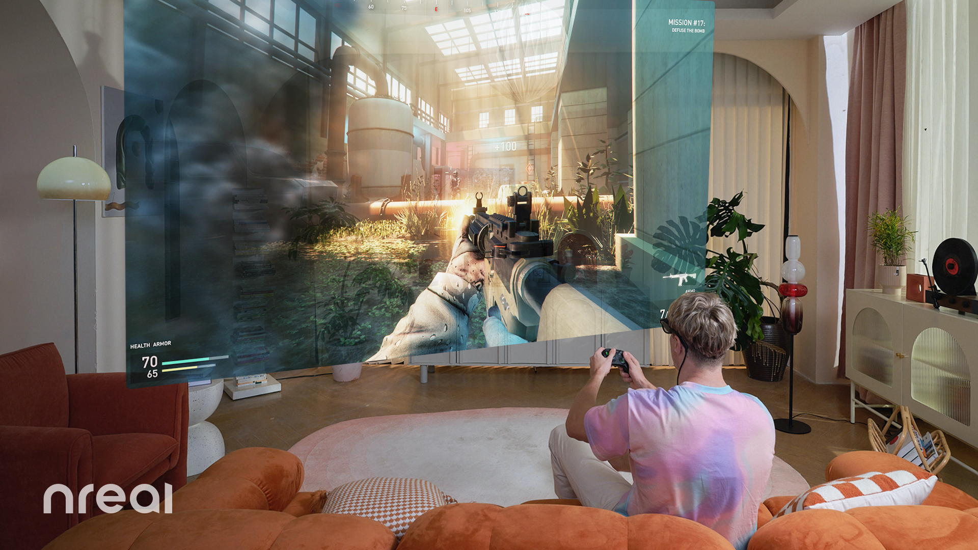The Nreal Air AR glasses being used to see a video game screen while some holds a controller in their living room, they're sat on the couch with pillows all around them