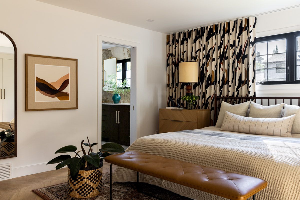 Principal bedroom with bed and behind bed drapery