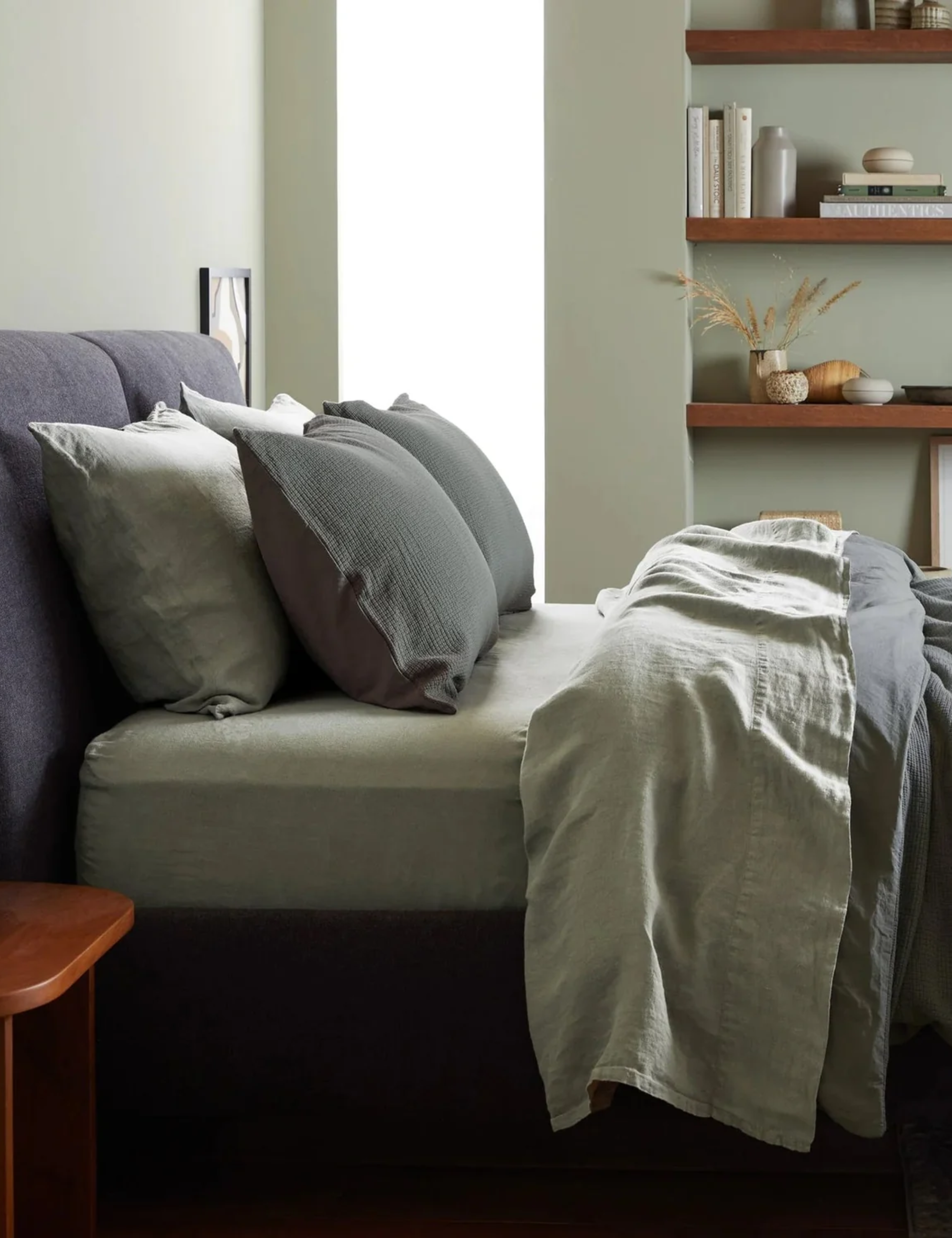 Moss green bed sheets pictured in a moss green bedroom