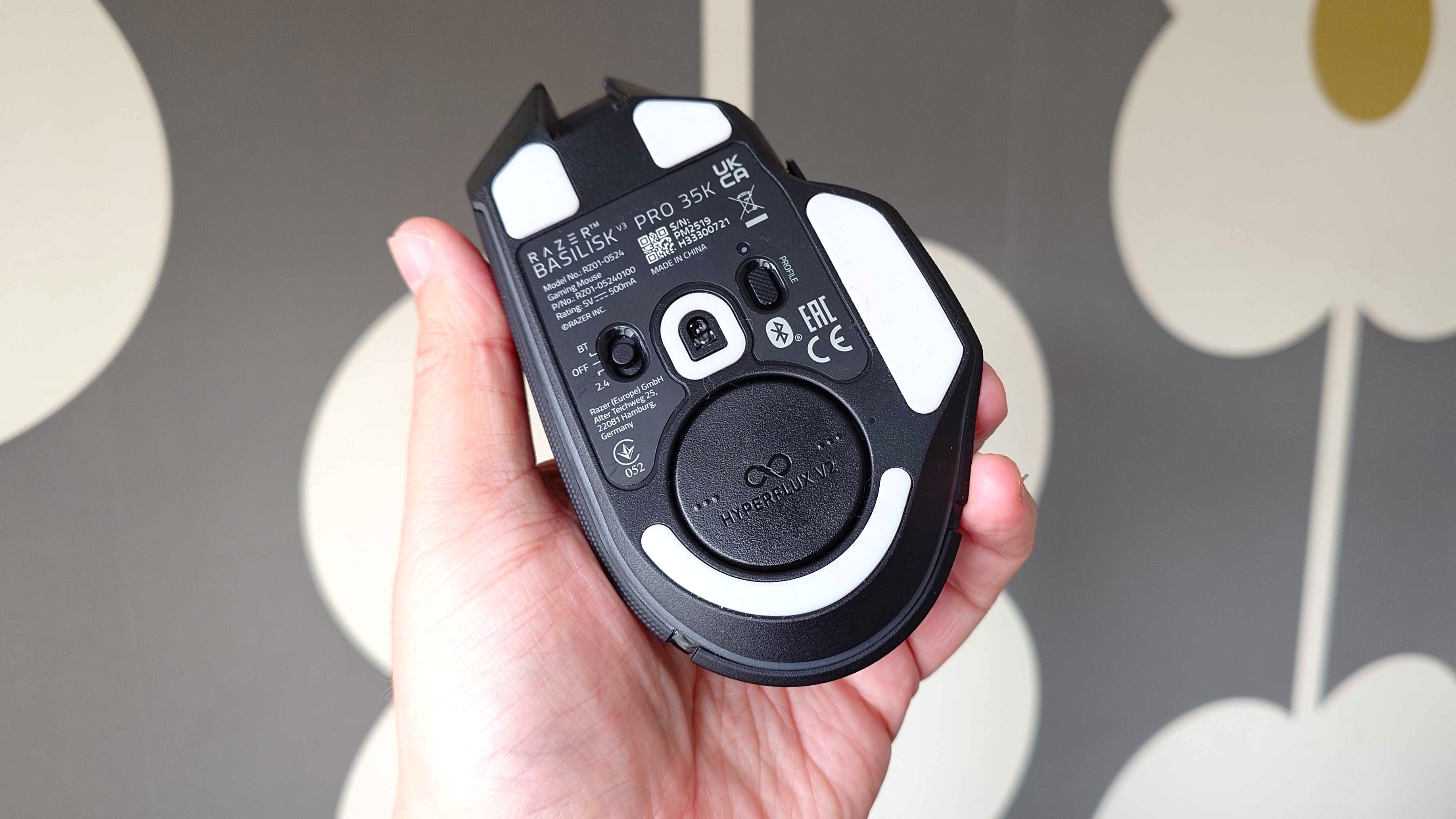 The Razer HyperFlux V2 charging puck in the bottom of a Basilisk V3 Pro 35K mouse.