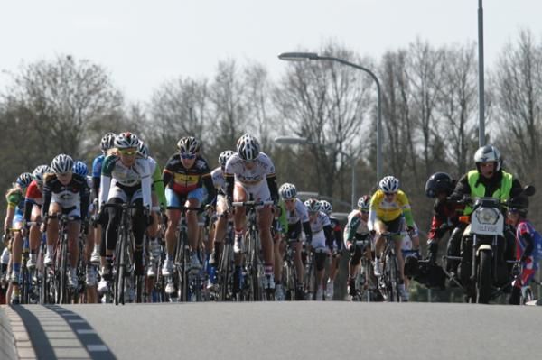 The peloton rides next to the television camera crew