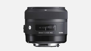 Sigma 30mm f/1.4 DC HSM A prime lens on a plain background