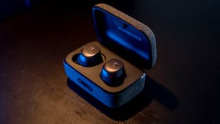 Angled view of Sennheiser Momentum True Wireless 3 earbuds in case.