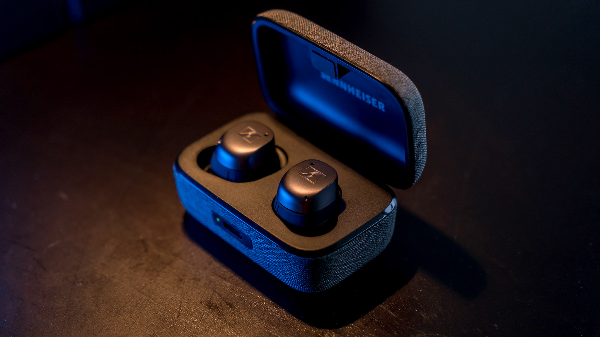 Angled view of Sennheiser Momentum True Wireless 3 earbuds in case.
