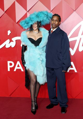 Rihanna and ASAP rocky on the red carpet at the 2024 fashion awards where rihanna wears a blue fur dress and a matching hat